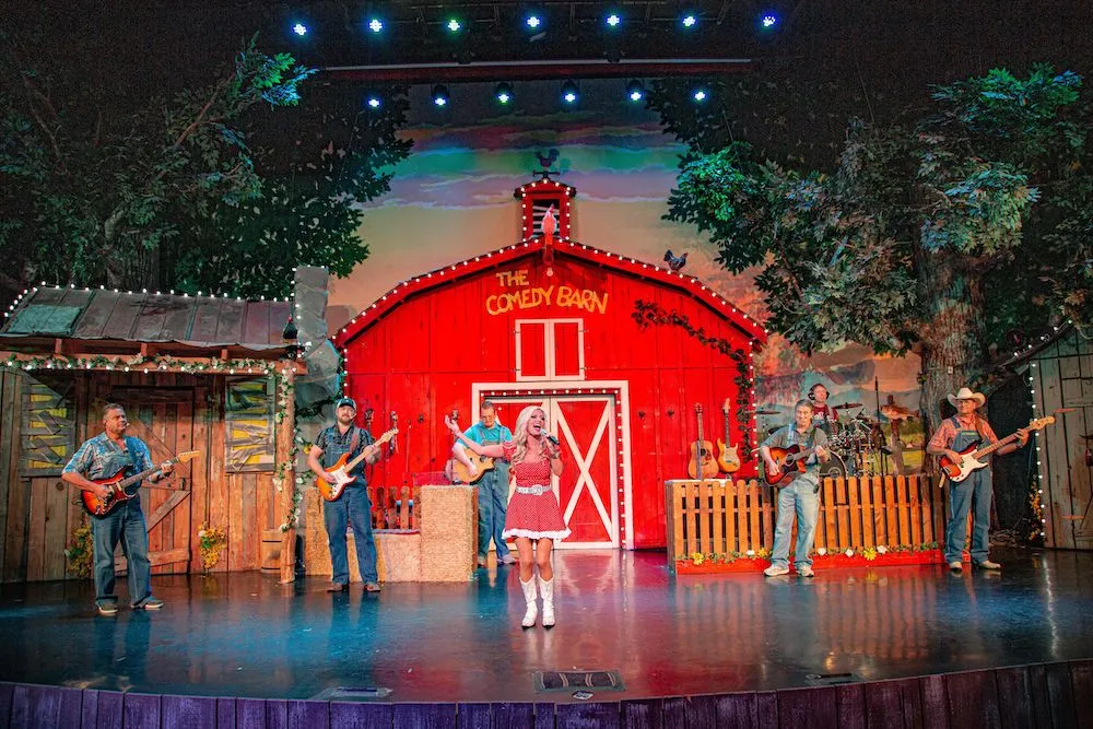 performers on stage singing at The Comedy Barn in Pigeon Forge