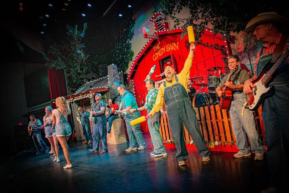 cast of The Comedy Barn dancing on stage