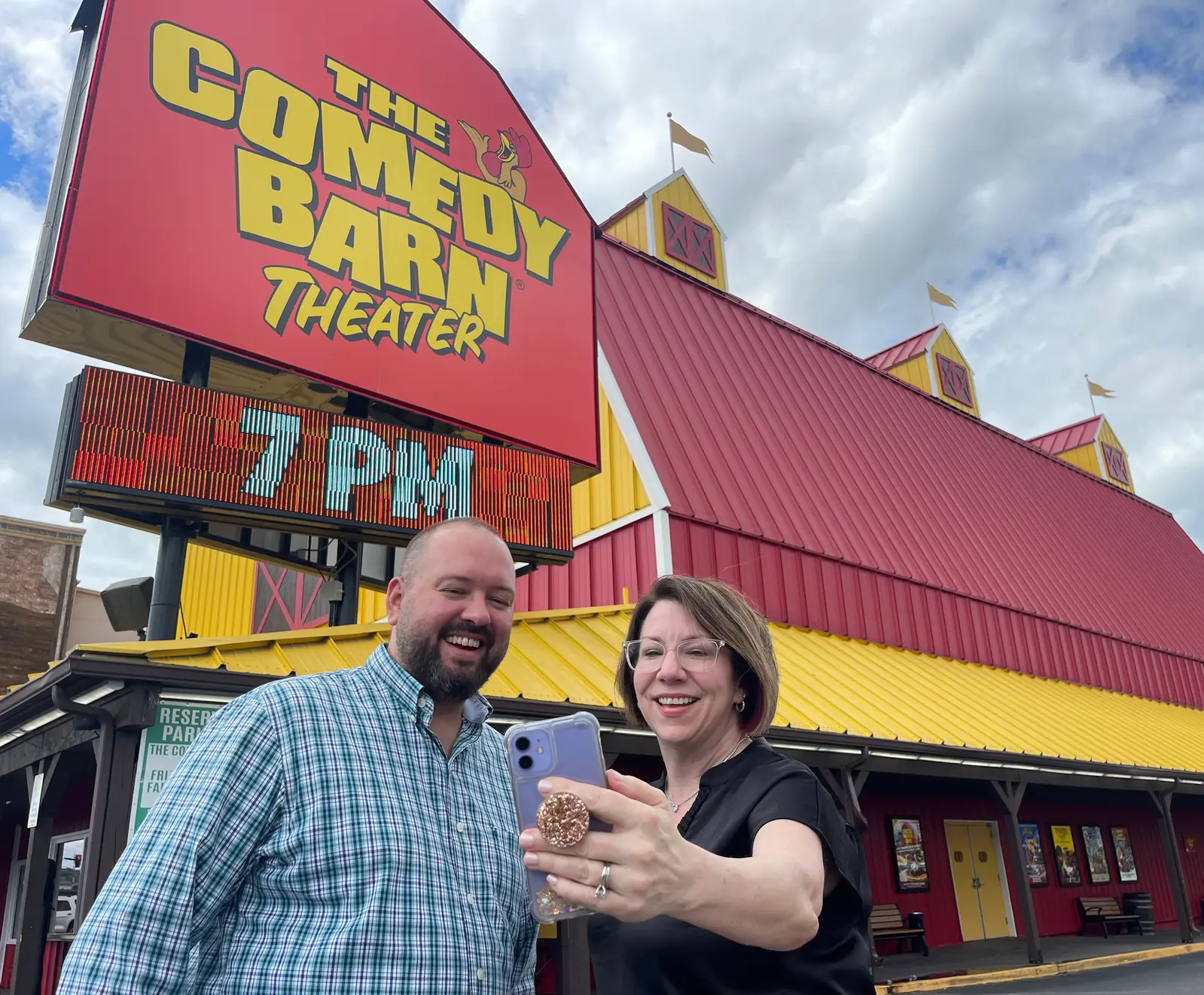 Collaborators standing in front of The Comedy Barn 